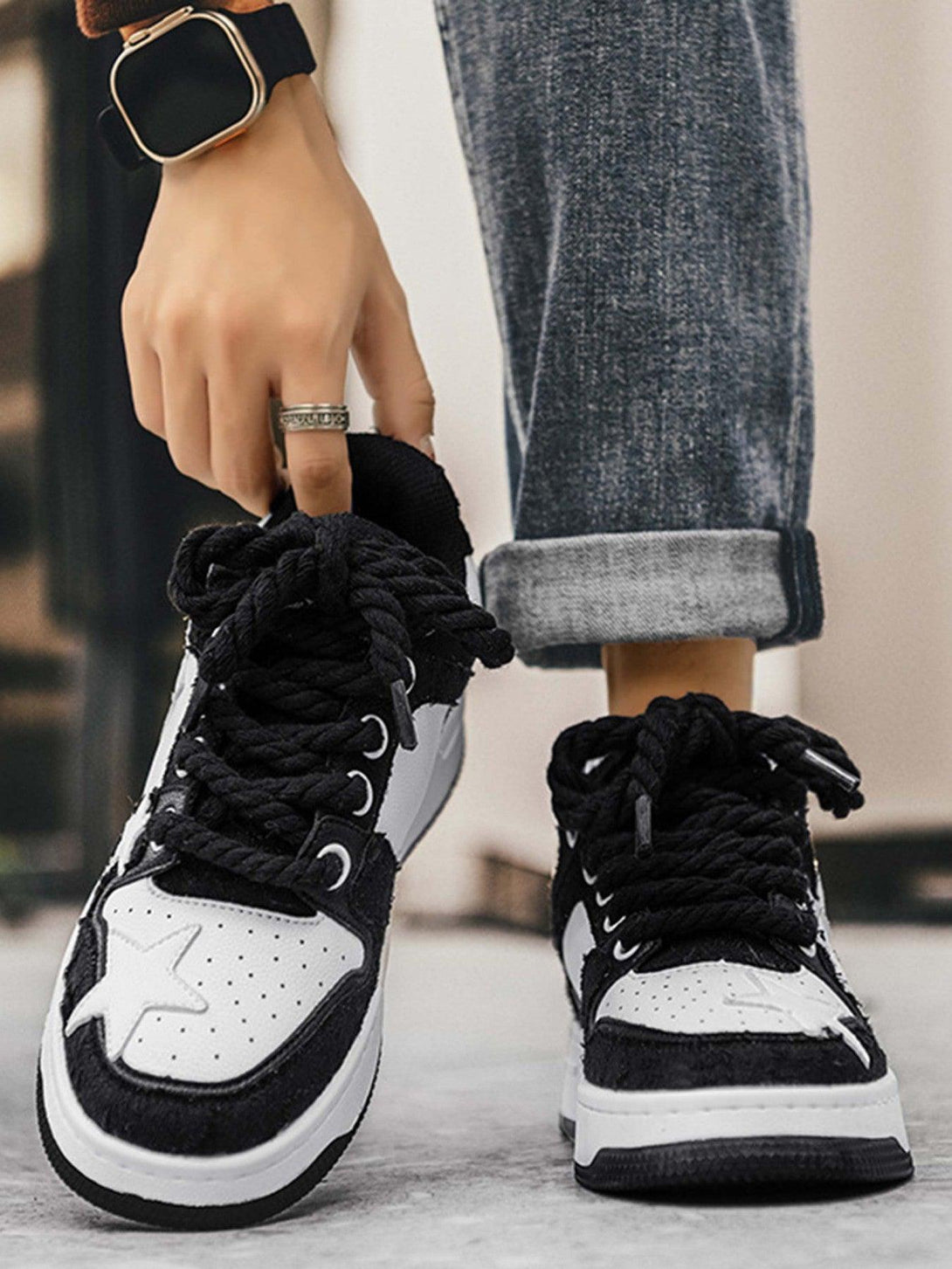 Stylish TALISHKO retro casual sneakers with star accents, paired with rolled jeans for a trendy look.