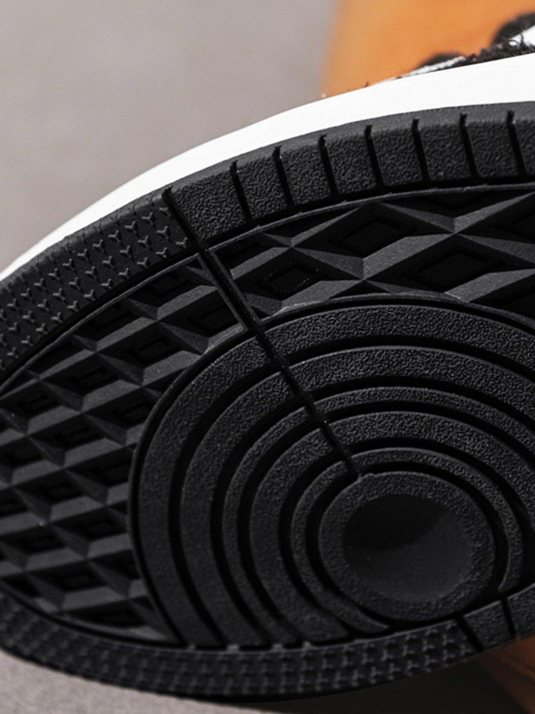 Detailed view of the TALISHKO retro casual sneaker sole, highlighting unique tread design.