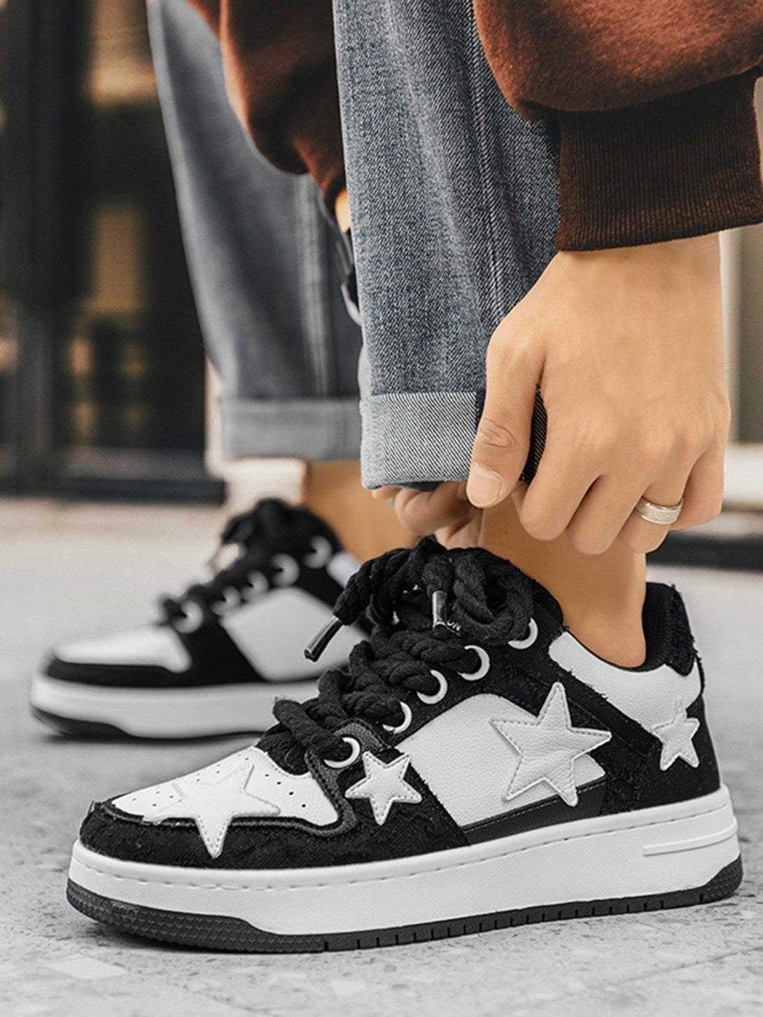 TALISHKO retro casual sneakers with star accents styled with rolled jeans, showcasing a trendy look.