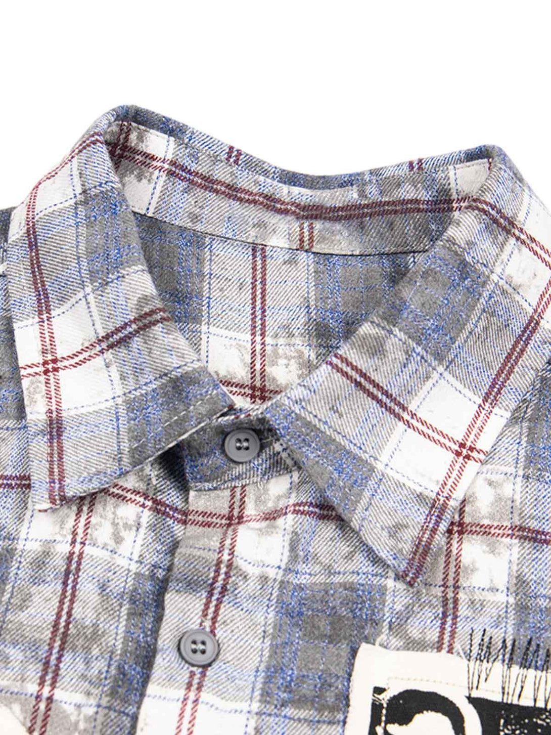 Detailed view of a plaid shirt collar and buttons by TALISHKO, highlighting retro flair.