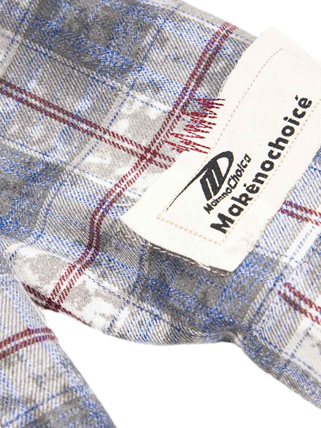 Zoomed-in view of a TALISHKO plaid shirt, showcasing intricate patchwork and textures.