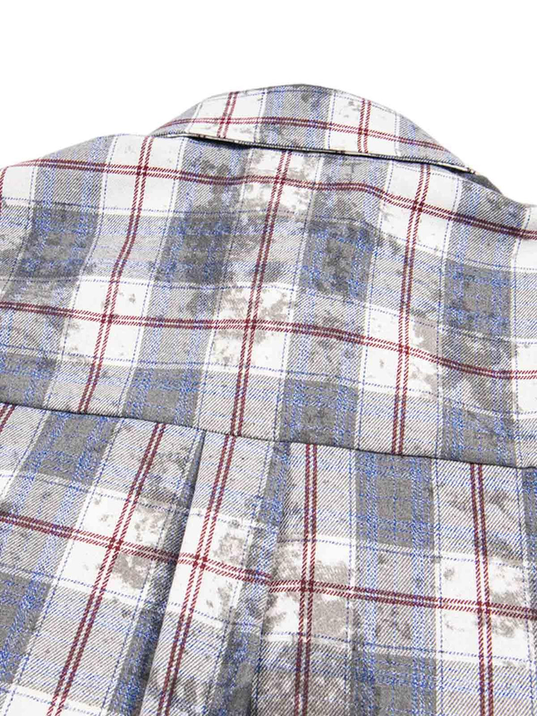 Intricate pattern detail on a TALISHKO plaid shirt, highlighting retro-inspired textures.
