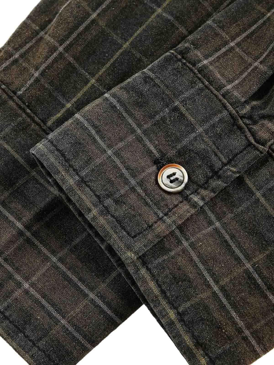 Intricate look at TALISHKO's retro plaid shirt cuff, featuring detailed button and stitching.