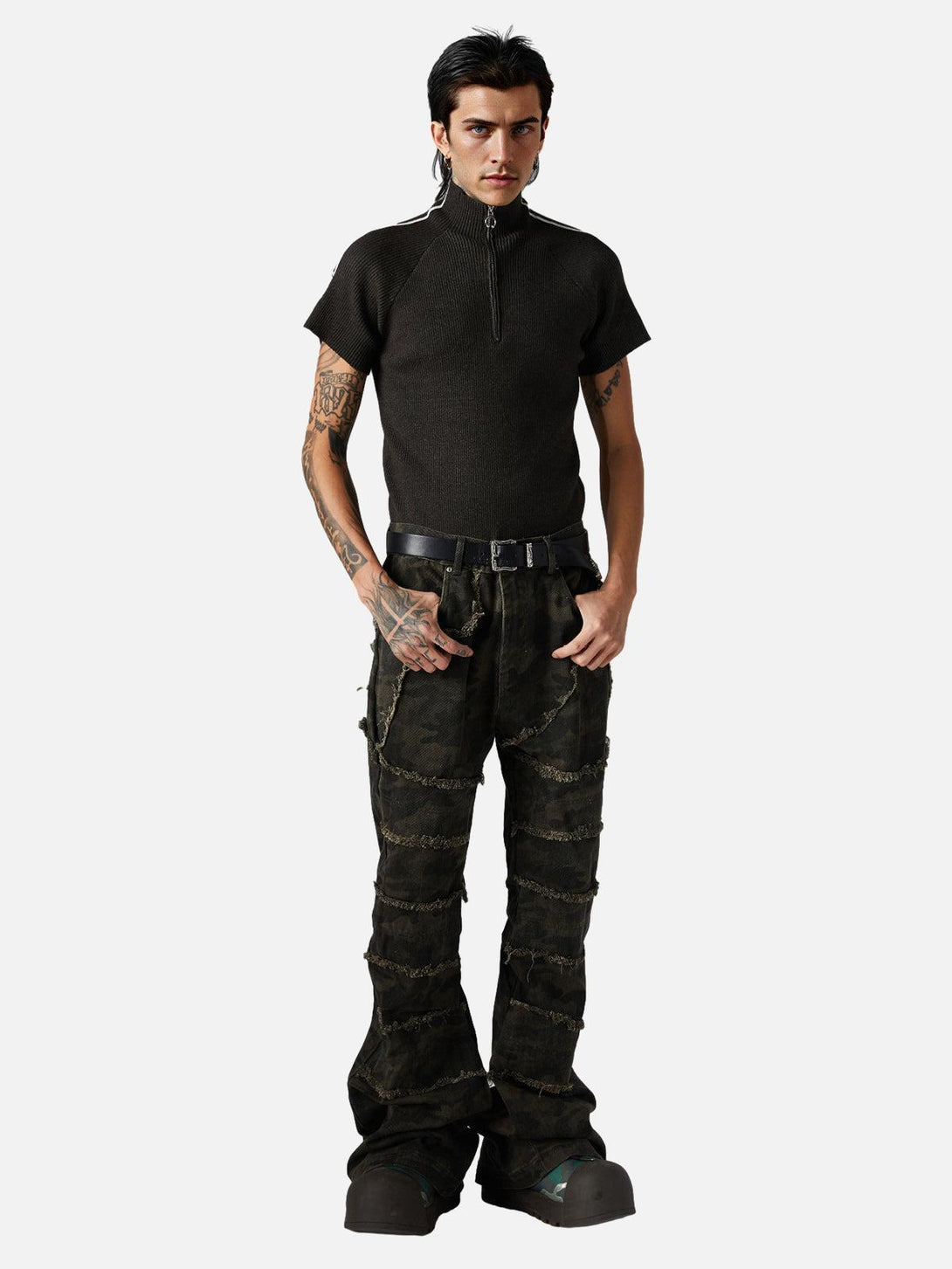 Model in a stylish retro quarter zip-up T-shirt by TALISHKO, paired with distressed jeans.