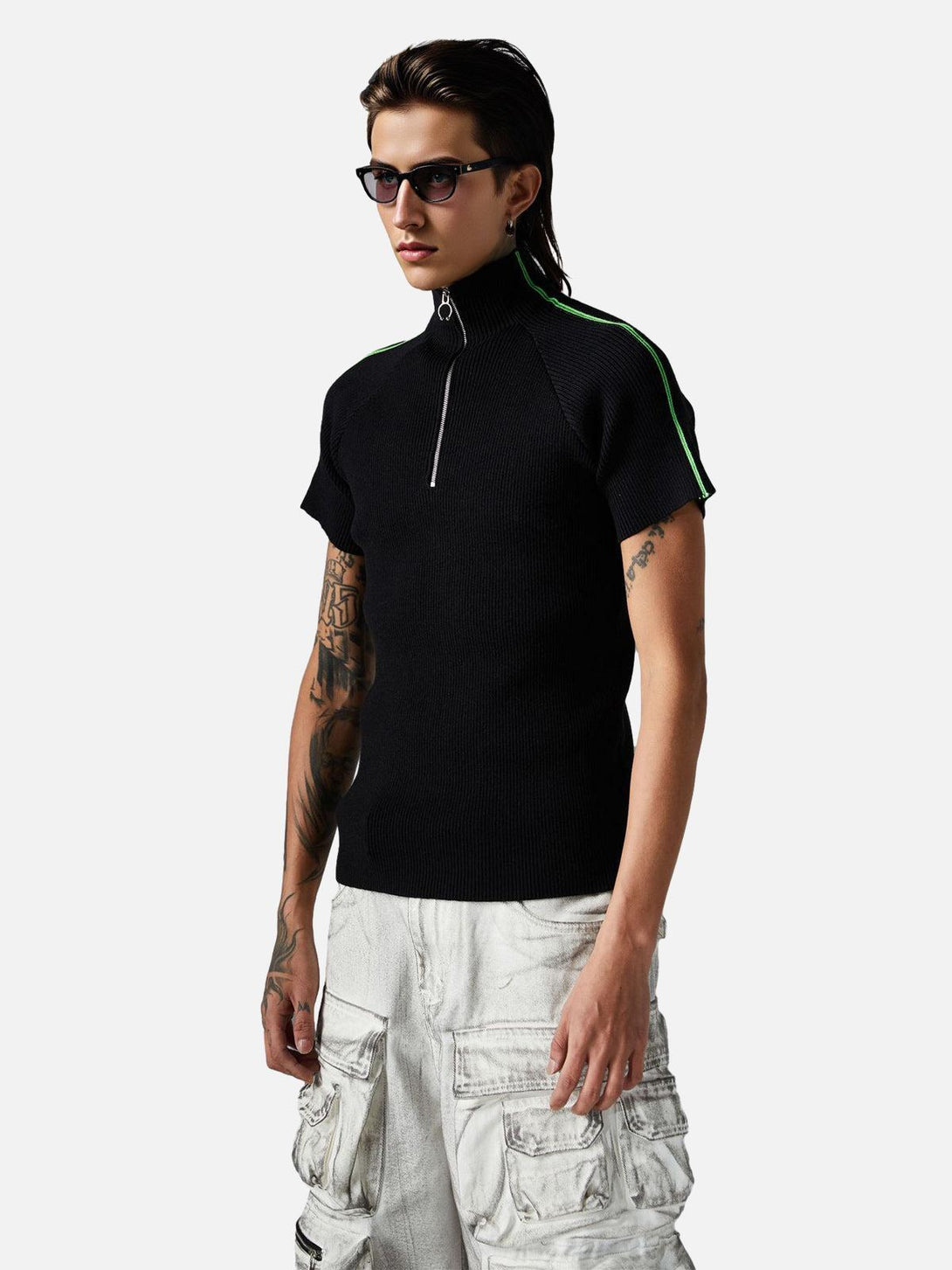 Model wearing a retro black quarter zip-up T-shirt by TALISHKO with green stripe accents.