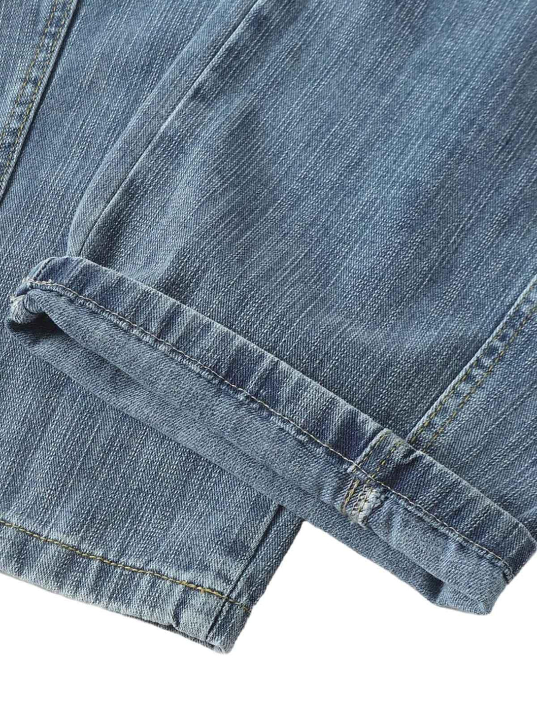 A close-up of TALISHKO's retro cleanfit washed baggy jeans, focusing on the cuff detail.