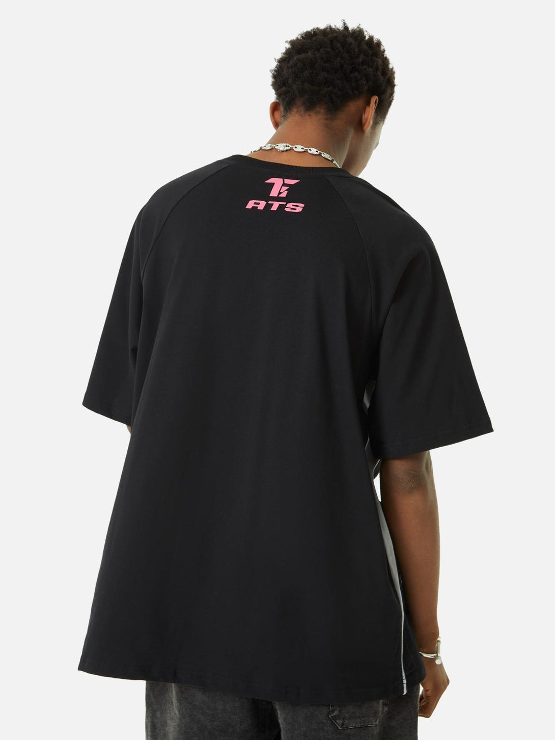 Back view of TALISHKO's racing T-shirt highlighting retro style with pink logo detail.