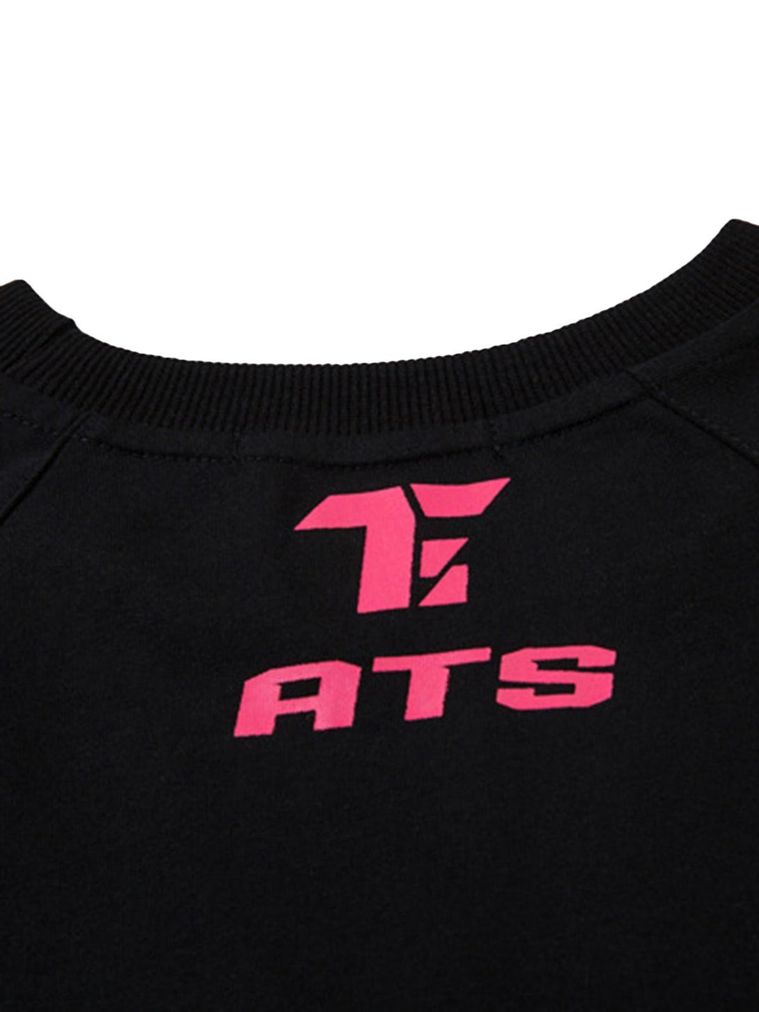 A detailed view of TALISHKO's black racing T-shirt featuring a prominent pink logo detail.
