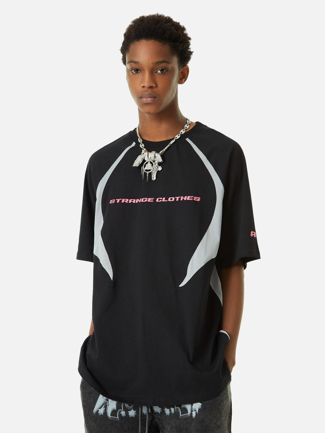 Model wearing TALISHKO's deconstructed racing T-shirt with bold, retro color-blocked style.