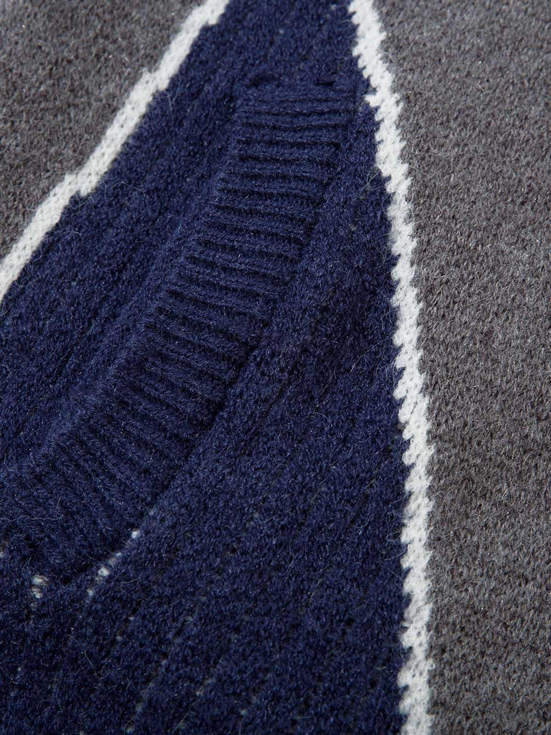 Zoomed-in texture of the TALISHKO retro contrast color cardigan sweater, highlighting knit patterns.