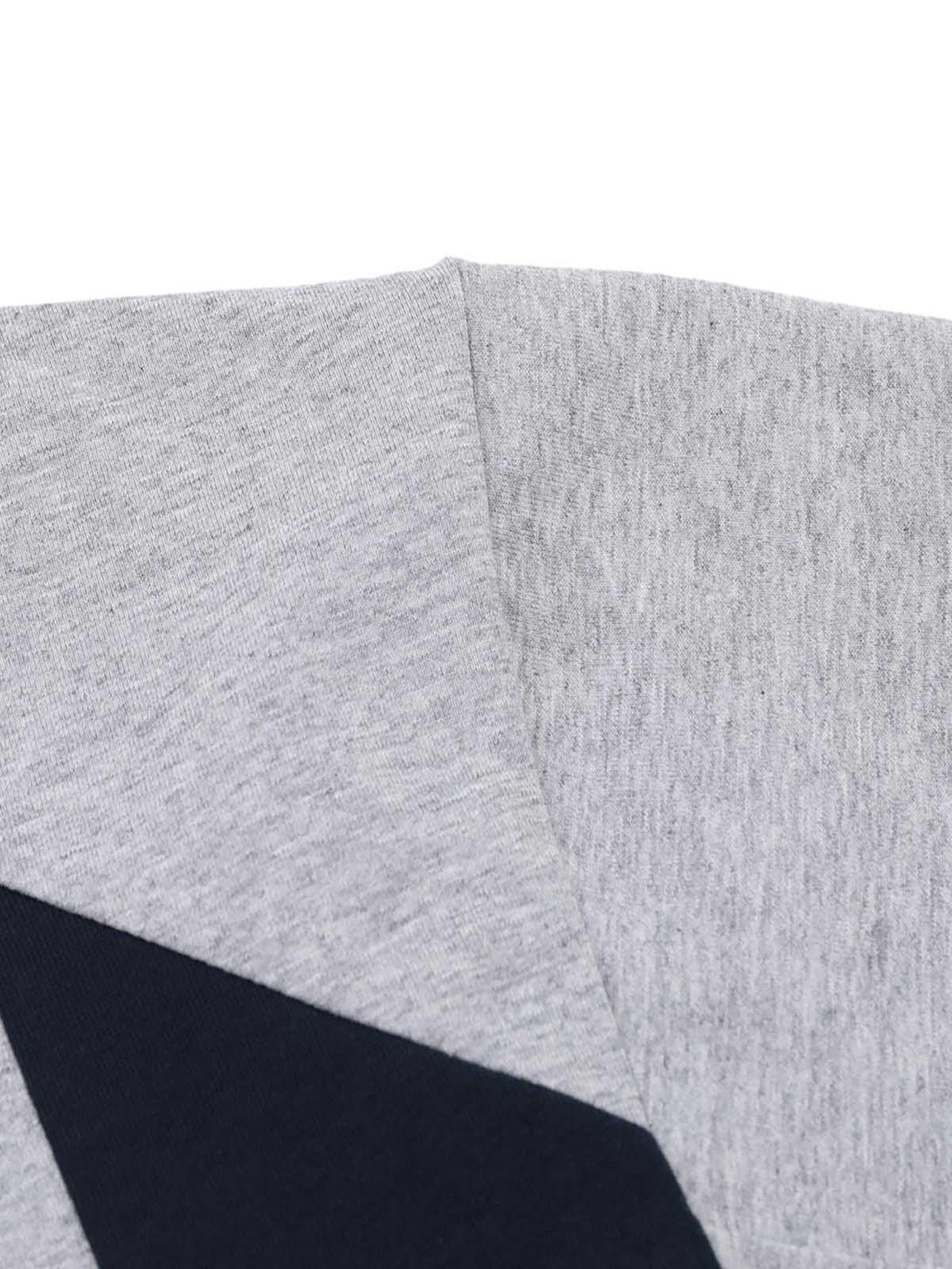 Detailed fabric and stitching of a gray T-shirt by TALISHKO, featuring contrast panels.