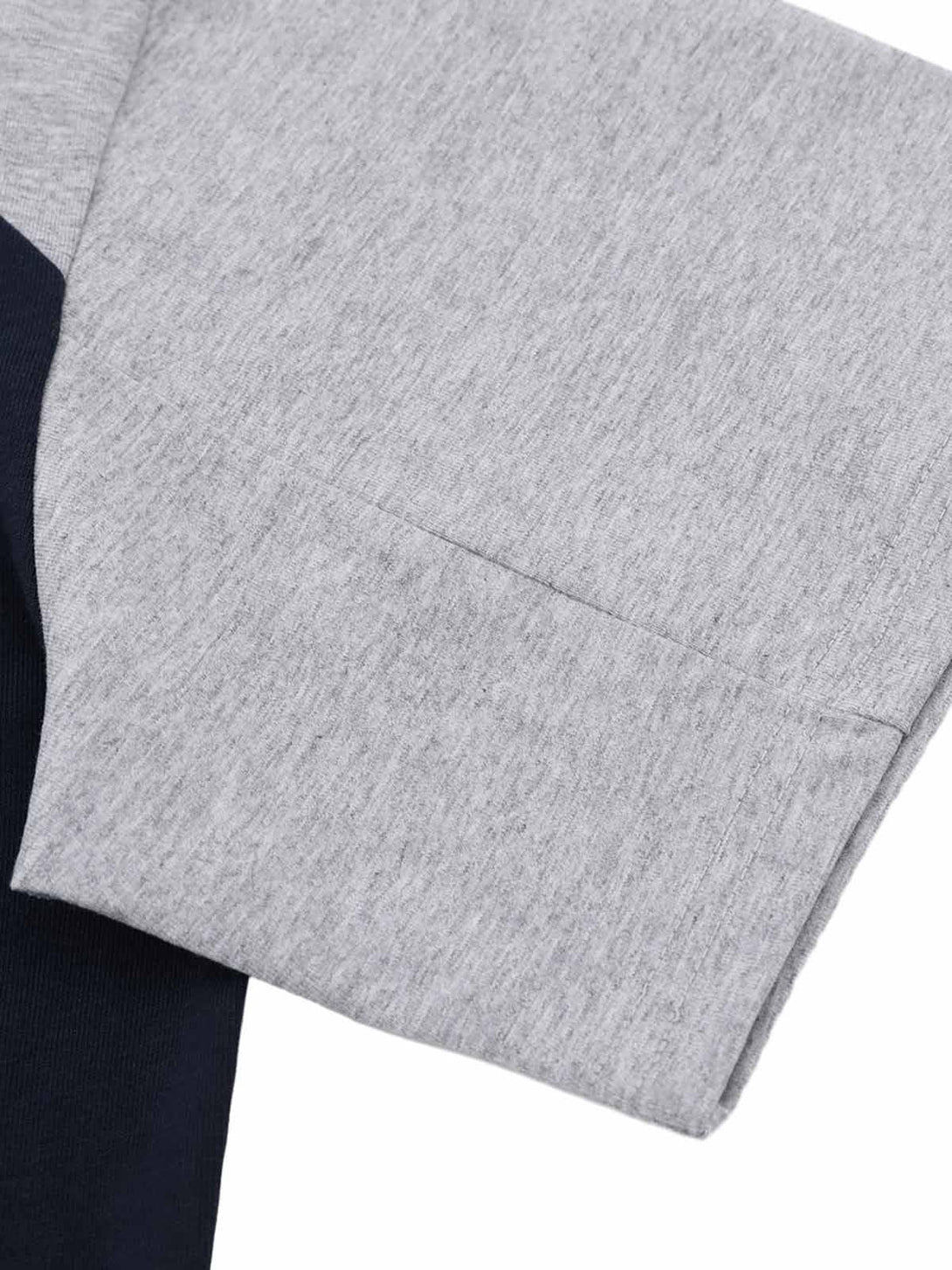 A tight crop highlighting the gray sleeve detail on a TALISHKO T-shirt with contrast design.