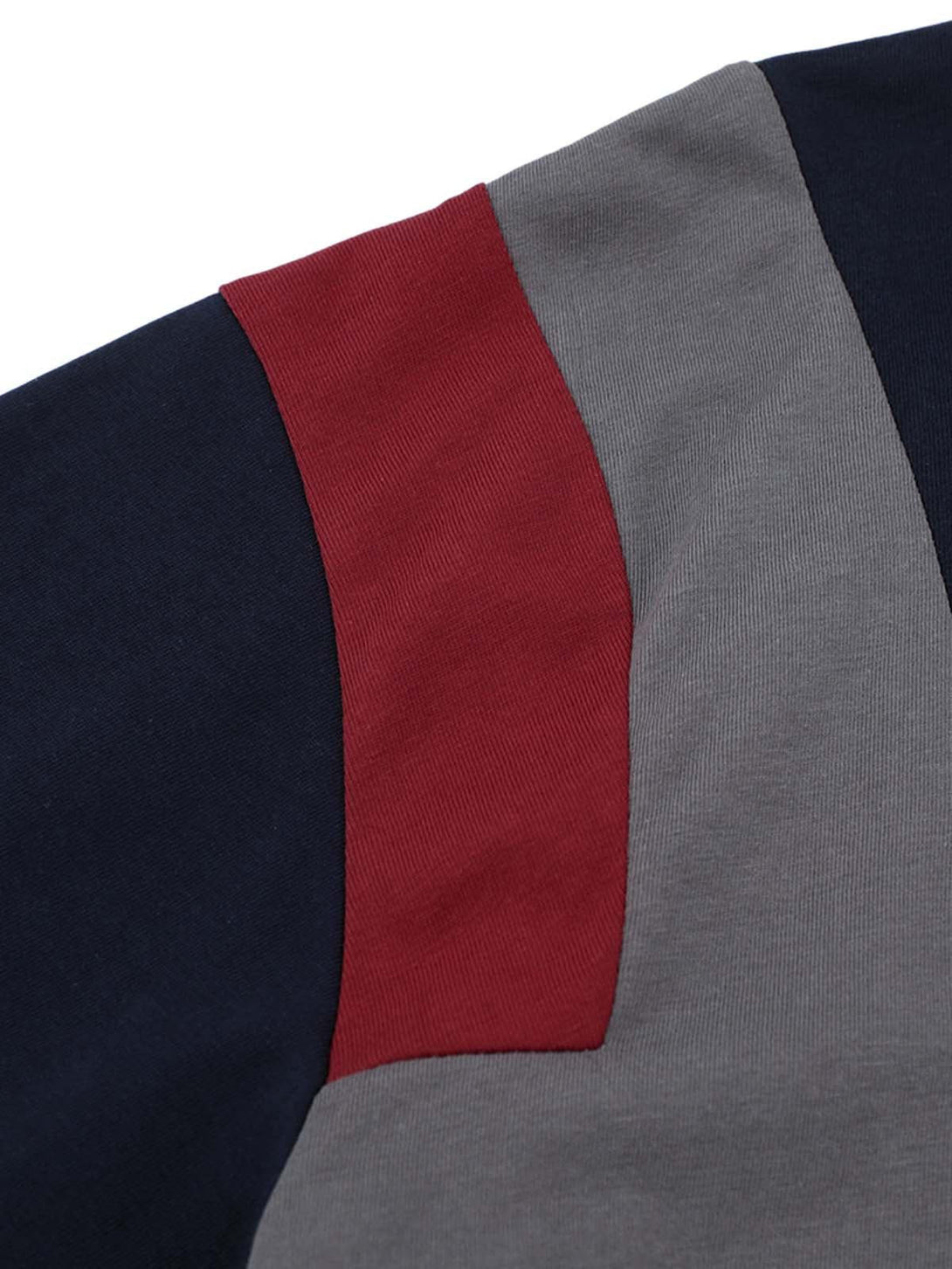 Intricate look at TALISHKO jersey T-shirt's retro contrast stitching in red, blue, and gray.