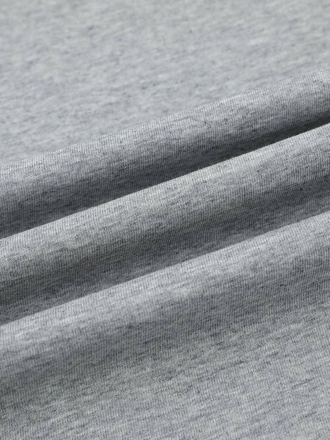 A tight crop highlighting TALISHKO T-shirt's fabric texture with retro contrast stitching.