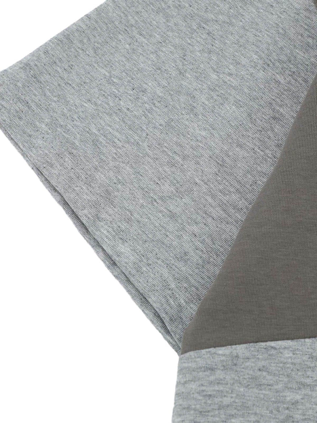 Zoomed-in texture of TALISHKO T-shirt fabric, showcasing retro contrast stitching details.