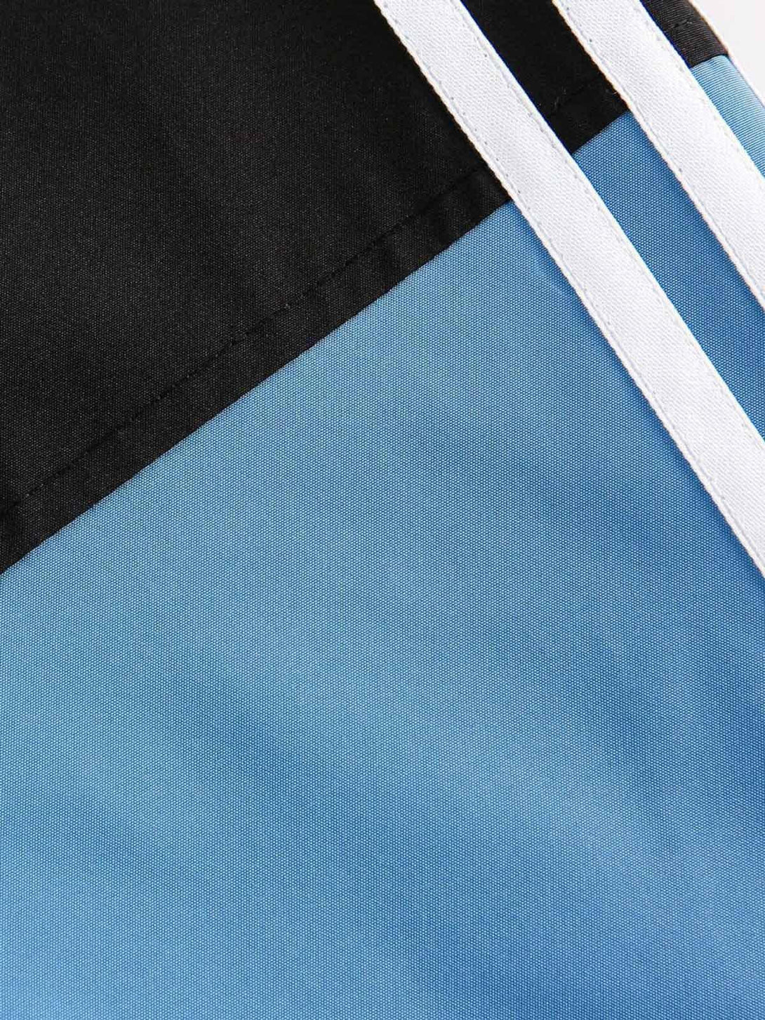 A detailed view of TALISHKO's retro jersey jacket, highlighting contrast color stitching and texture.