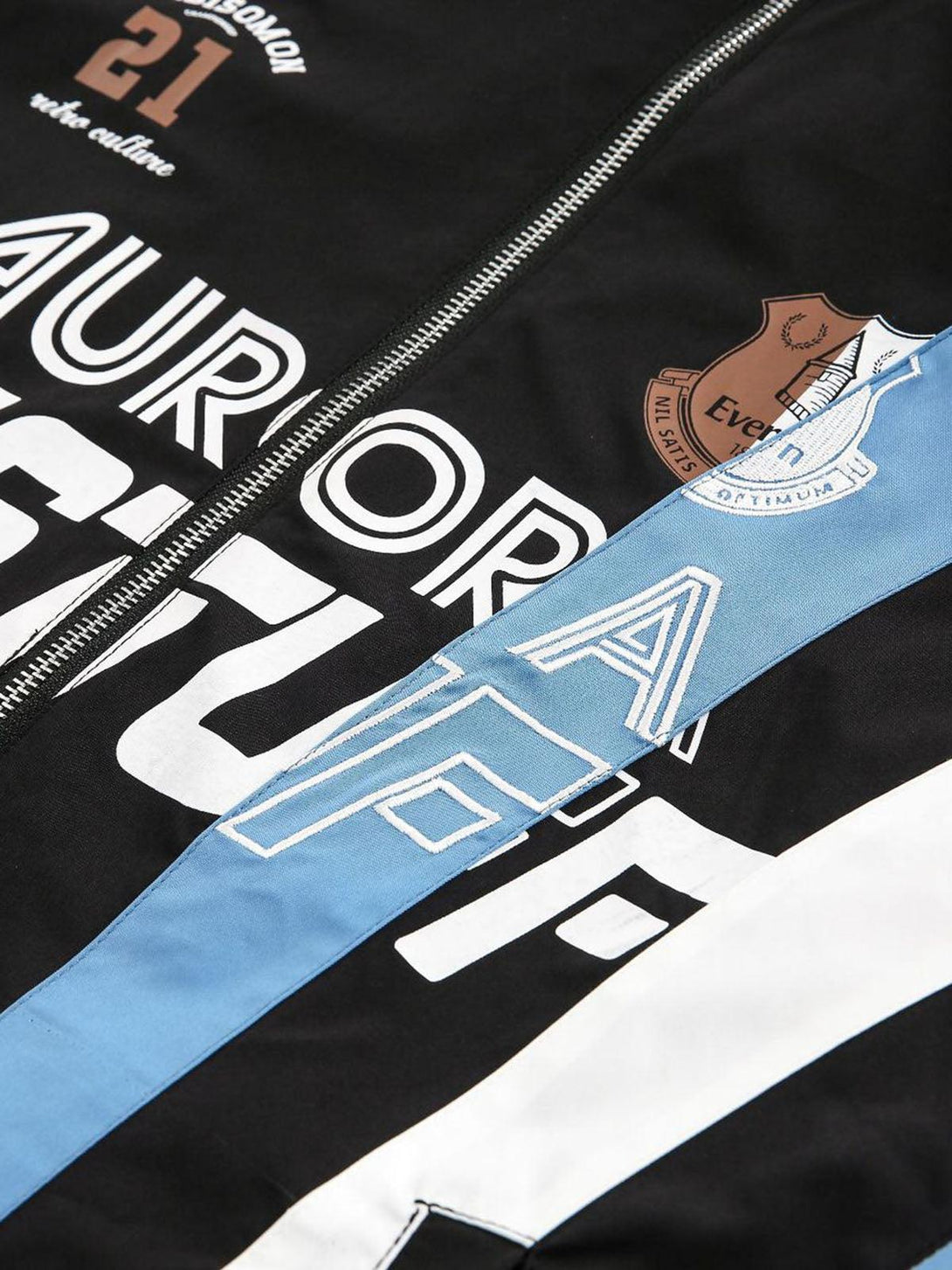 Detailed view of TALISHKO's retro jersey jacket, featuring unique graphic elements and stitching.