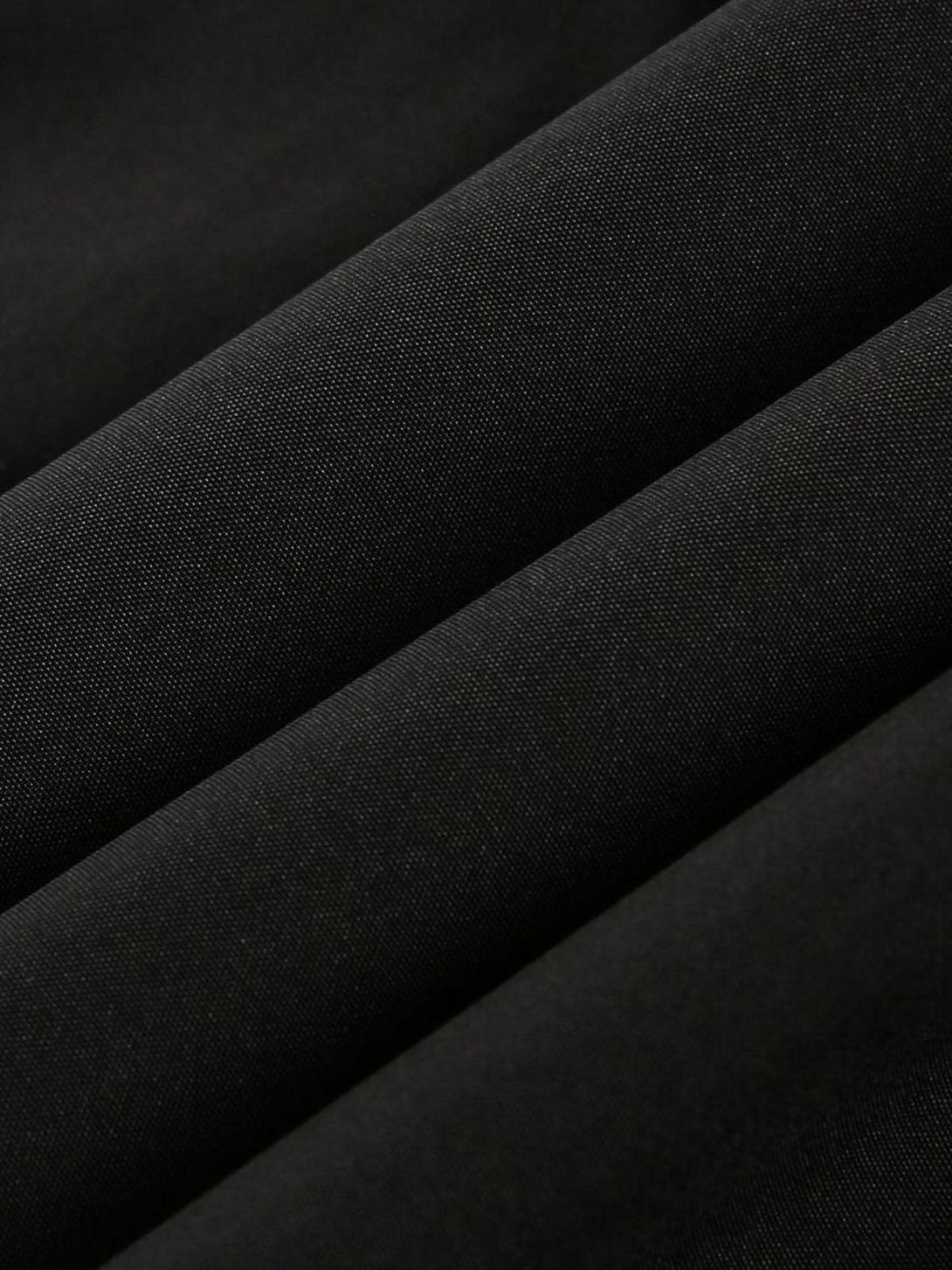 Zoomed-in texture of TALISHKO's retro jersey jacket, highlighting the intricate stitching.