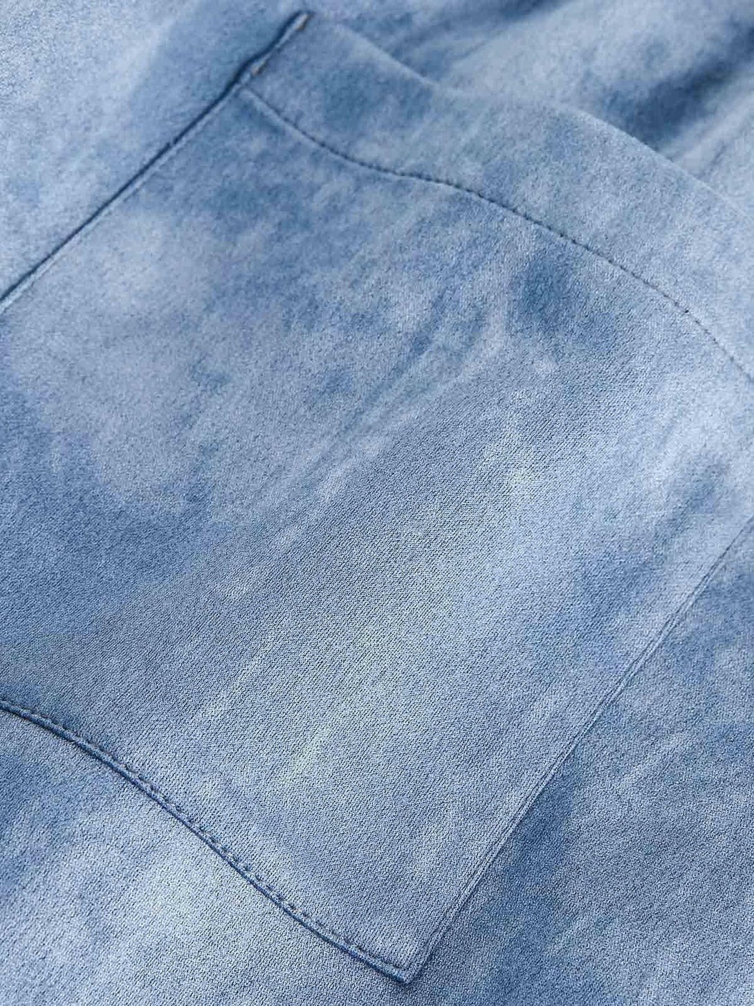 A detailed view of the pocket on a TALISHKO retro suede track jacket, showcasing texture.