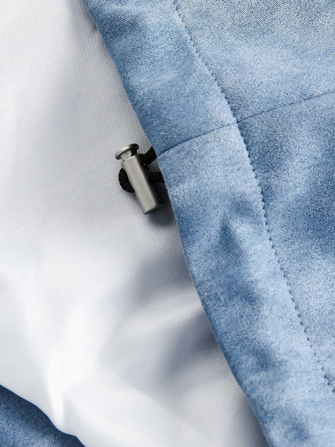 Focusing on the drawstring detail and fabric texture of the TALISHKO retro suede track jacket.