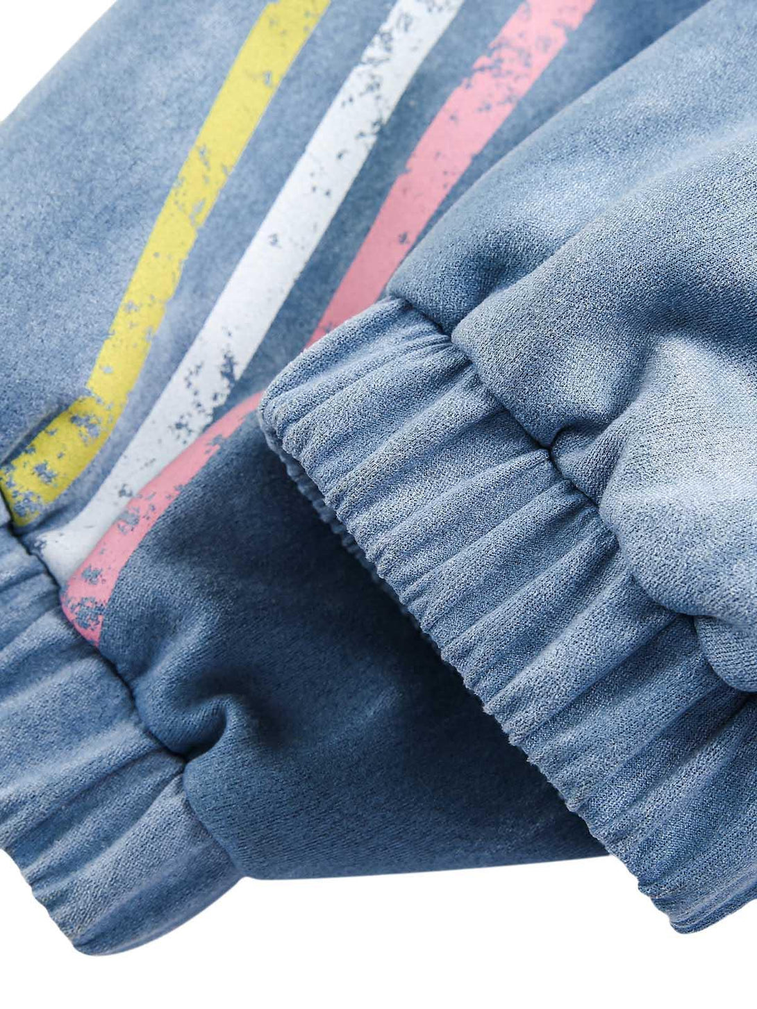 Elastic cuffs and retro stripes on a TALISHKO suede track jacket, emphasizing vintage style.