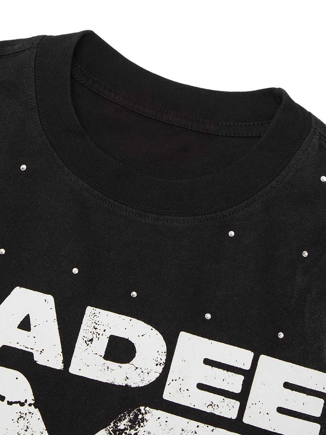 Intricate look at TALISHKO retro crystal letter T-shirt's distressed graphic and stud details.