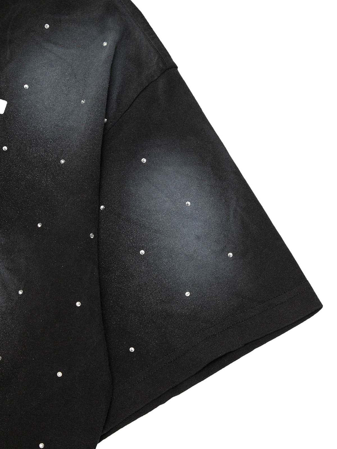 A close-up of TALISHKO's black T-shirt showcasing crystal dot embellishments and texture.