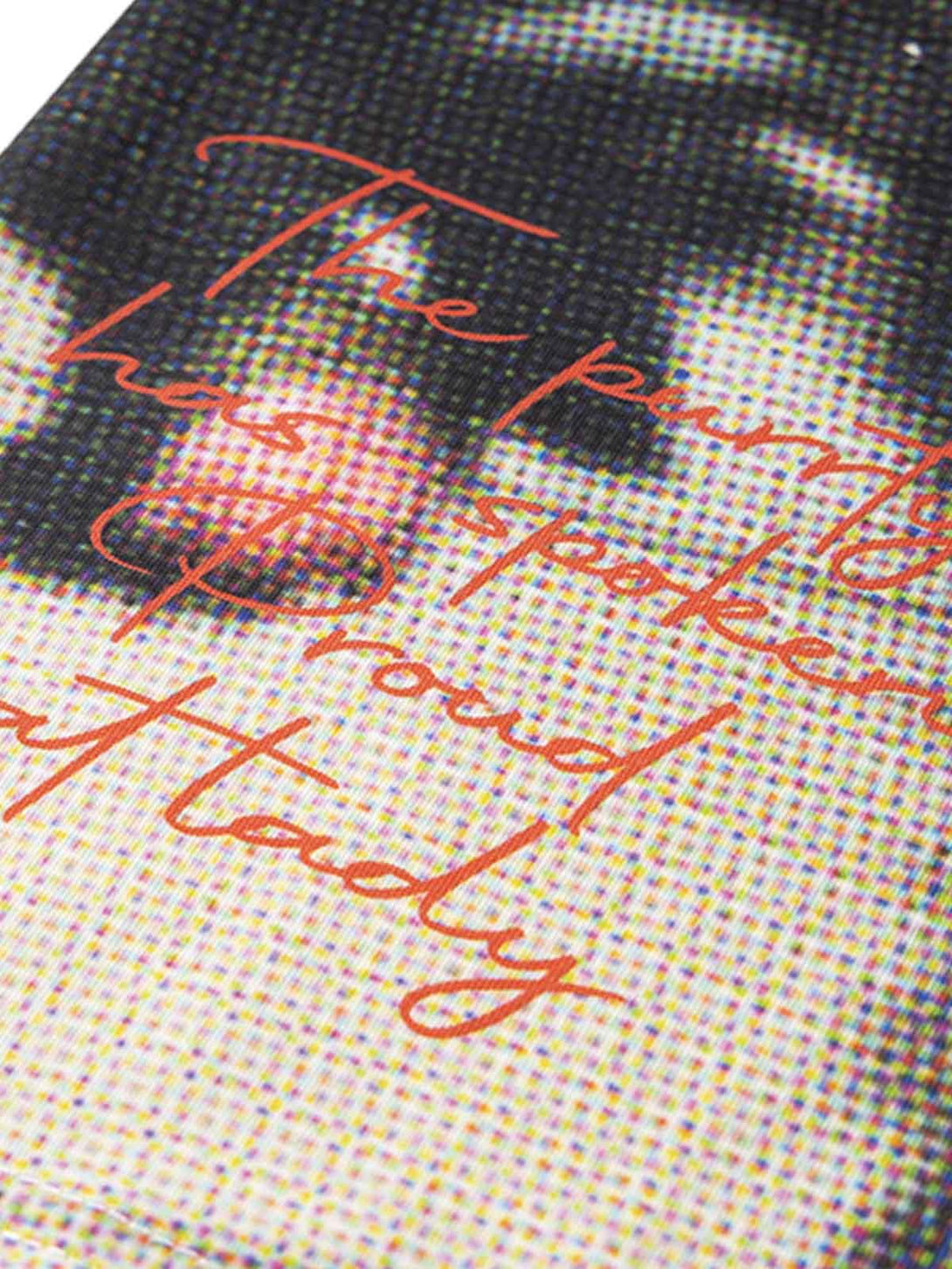 A tight crop highlighting the TALISHKO T-shirt's retro cat design, showcasing its unique texture.