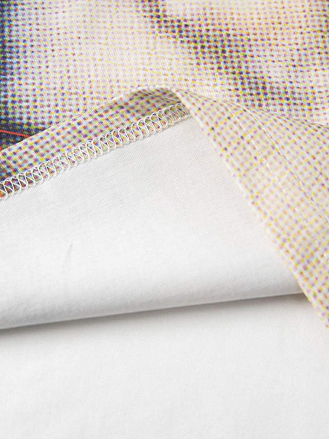 Intricate look at TALISHKO's retro cat print T-shirt fabric, highlighting vivid texture details.