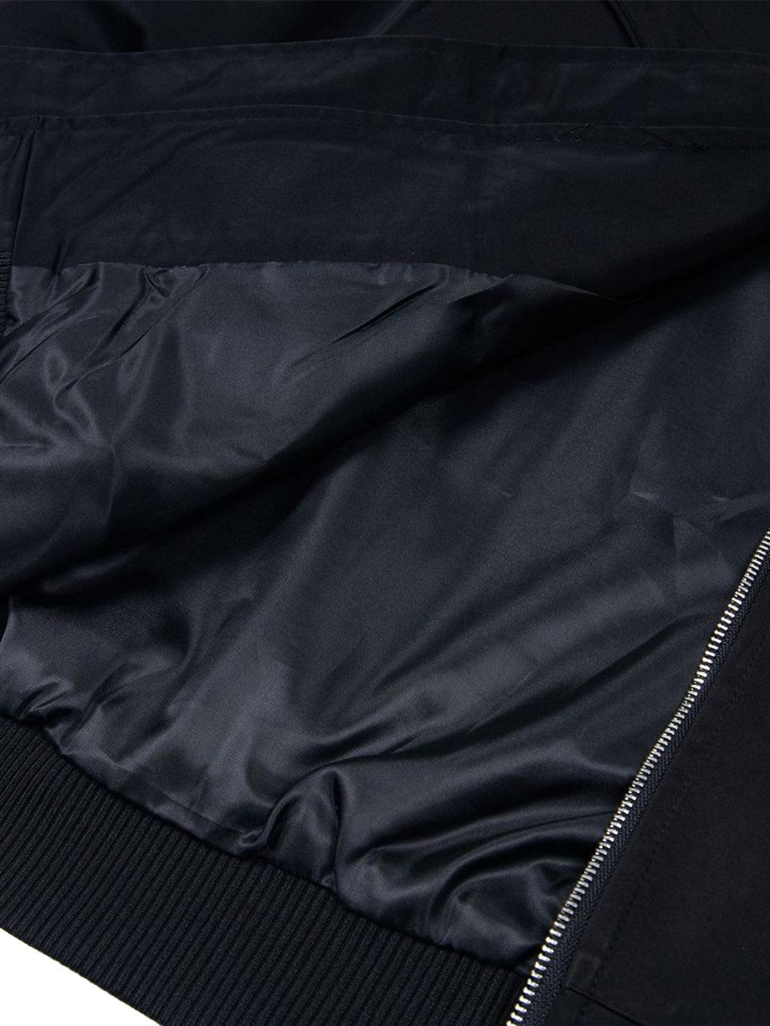 Focusing on the interior lining and zipper detail of TALISHKO's retro deconstructed bomber jacket.