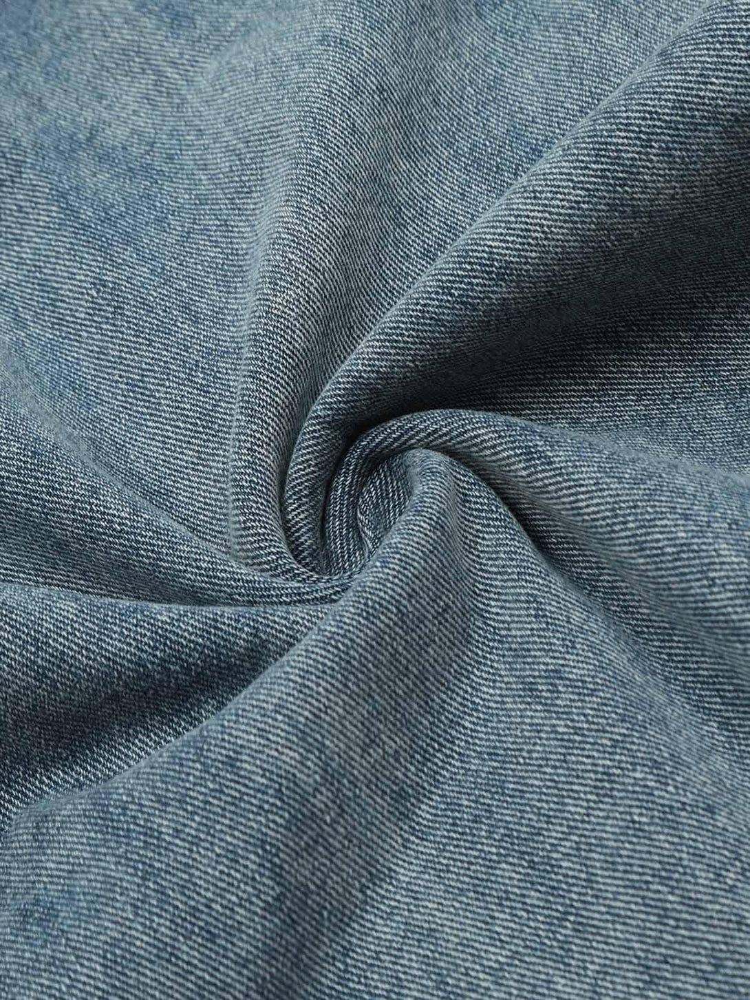Zoomed-in texture of TALISHKO's retro jeans fabric, showcasing the denim's intricate weave.
