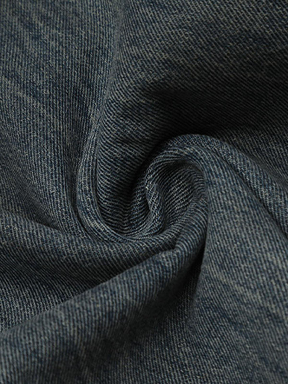 Intricate look at the textured fabric of TALISHKO's distressed faux two-piece jeans, ideal for edgy style.