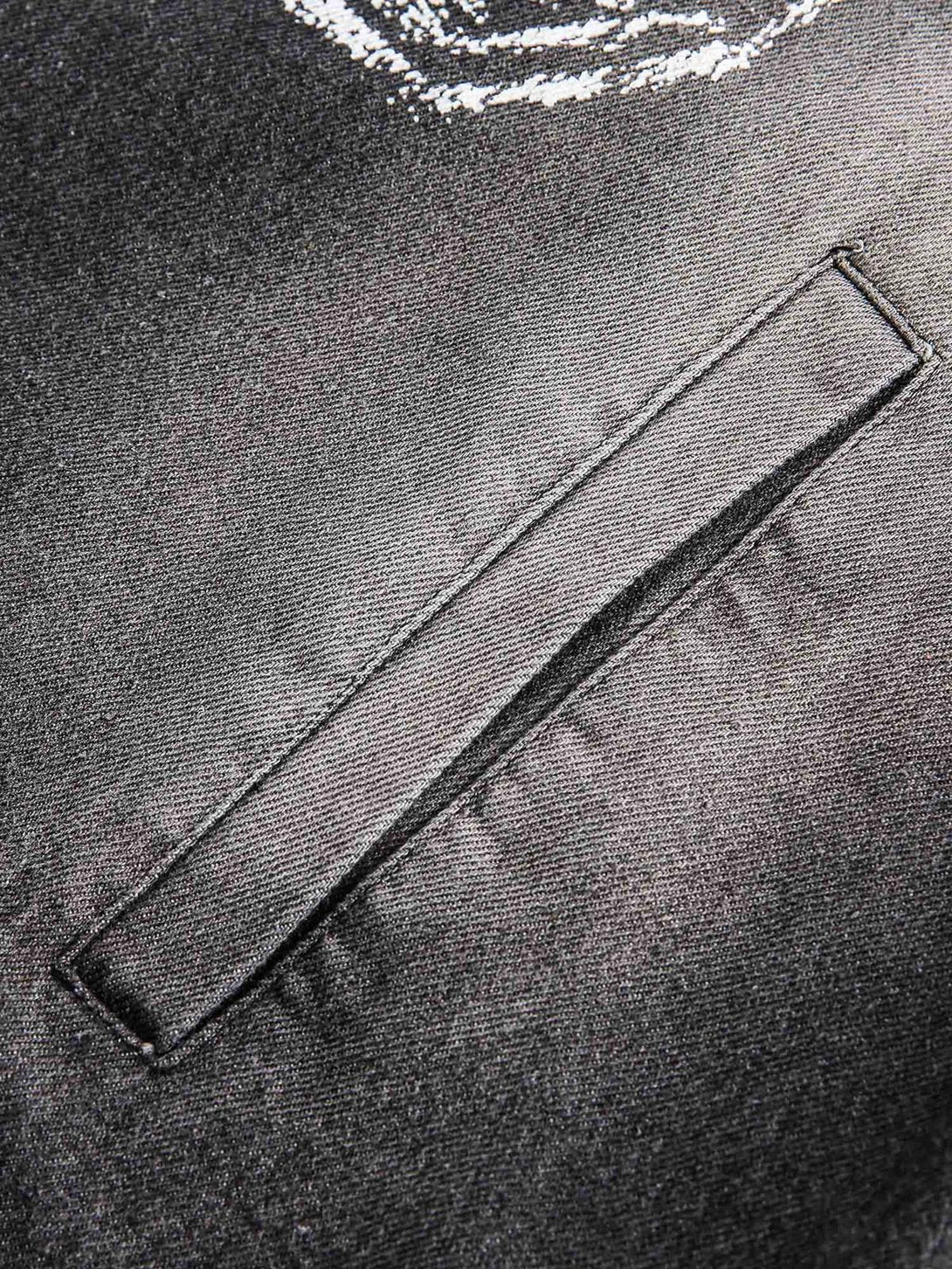 Focusing on the sleek pocket detail of TALISHKO's retro distressed denim hoodie.