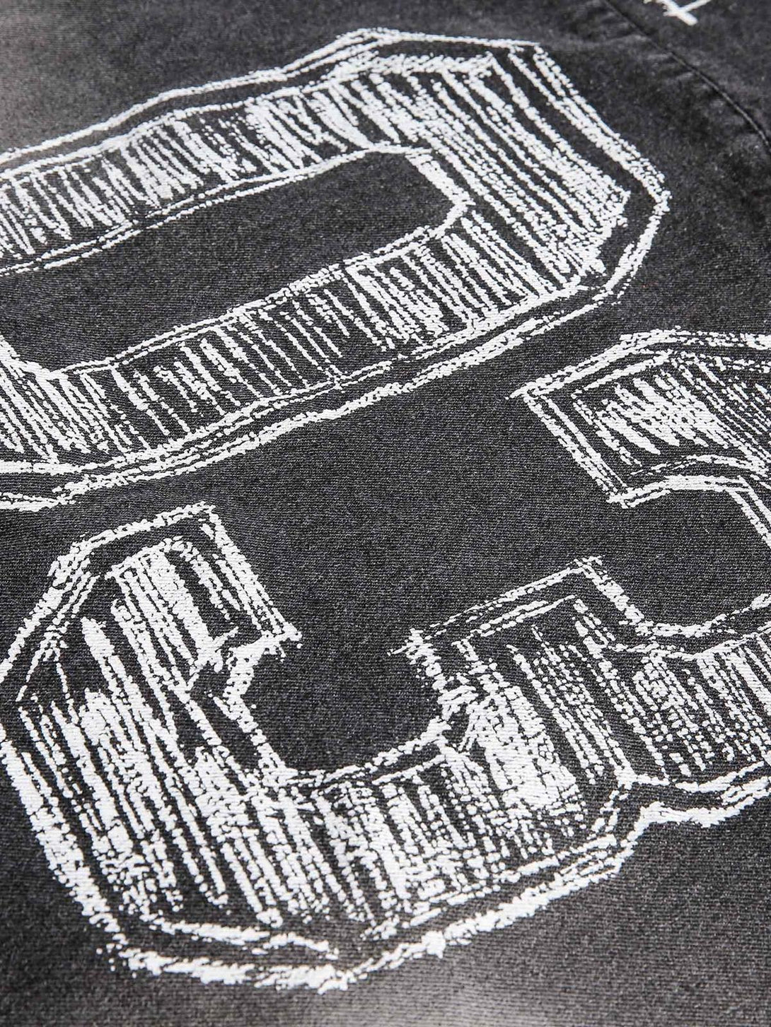 A detailed view of TALISHKO's denim hoodie, showcasing the bold "03" design on distressed fabric.