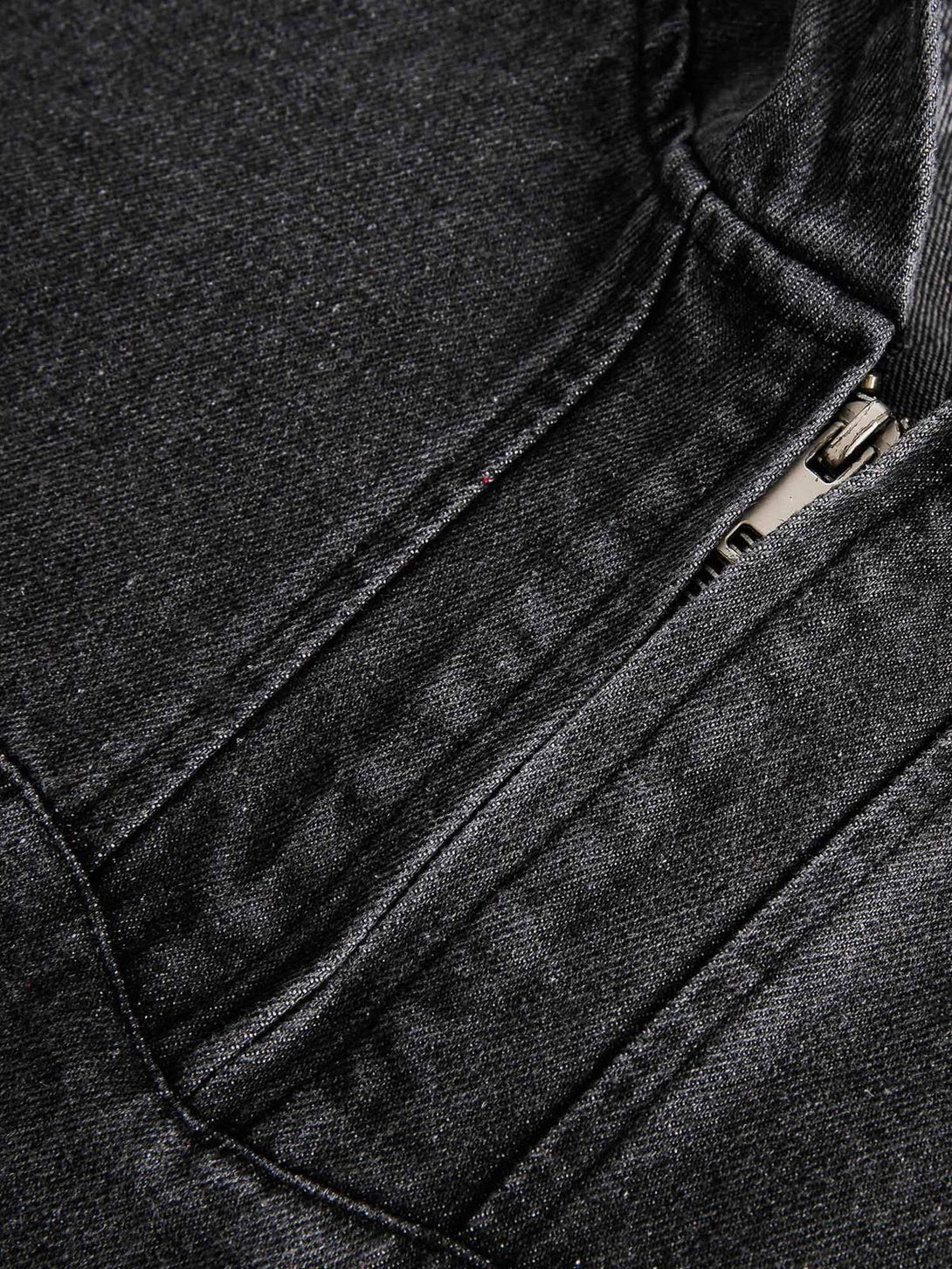 Detailed fabric and stitching on TALISHKO's denim hoodie, emphasizing the washed texture.
