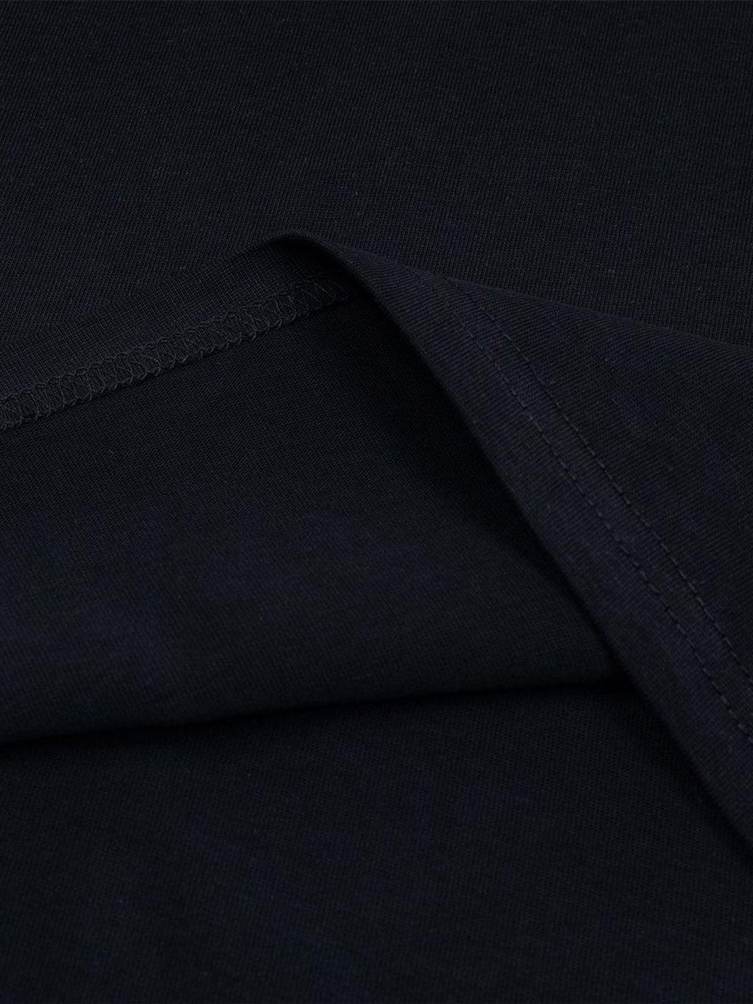 Detailed fabric and stitching on a black T-shirt by TALISHKO, highlighting its quality.