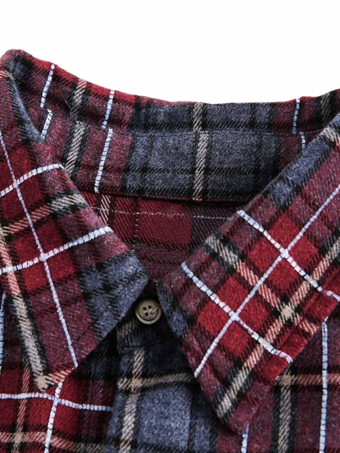 A detailed view of TALISHKO's retro plaid shirt collar, showcasing intricate pattern and texture.