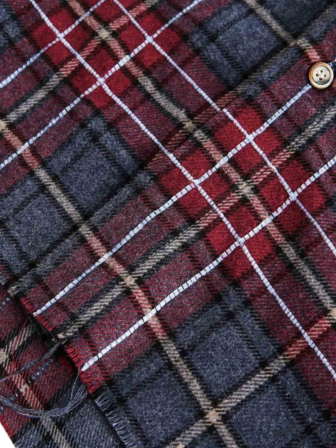 Detailed fabric and stitching of TALISHKO's retro faux two-piece plaid shirt in rich hues.