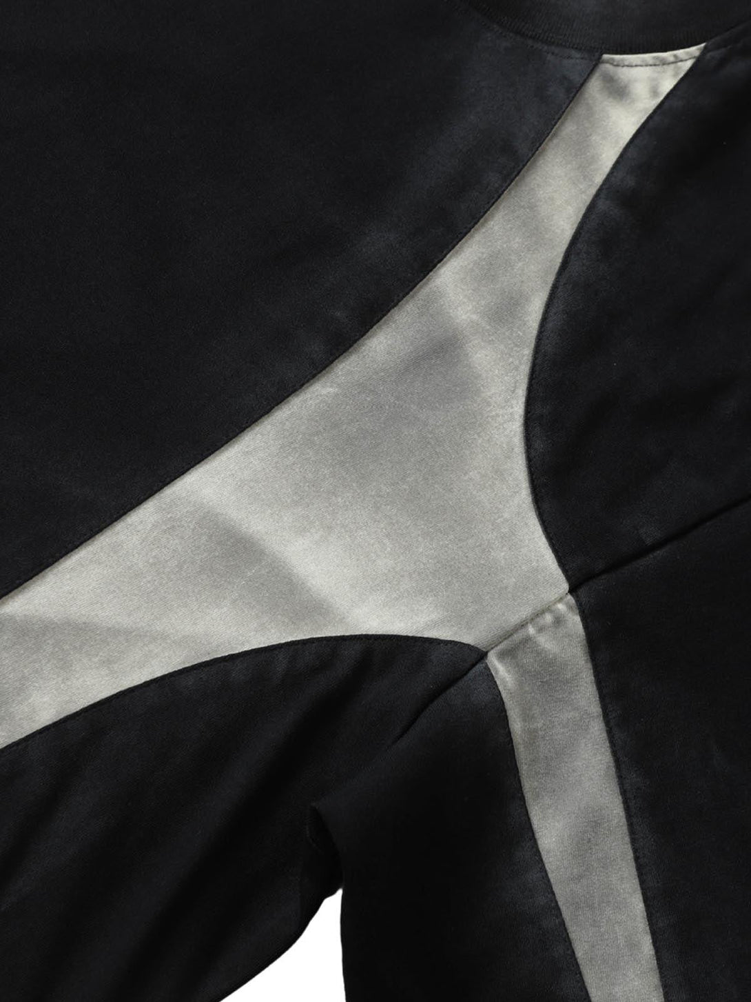 A detailed view of TALISHKO's retro patchwork T-shirt, highlighting unique texture and design.