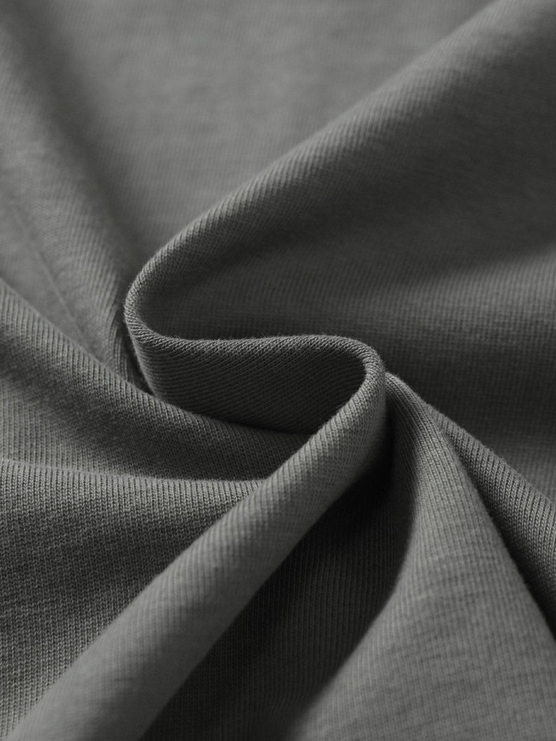 Zoomed-in texture of TALISHKO's retro patchwork T-shirt, showcasing detailed craftsmanship.