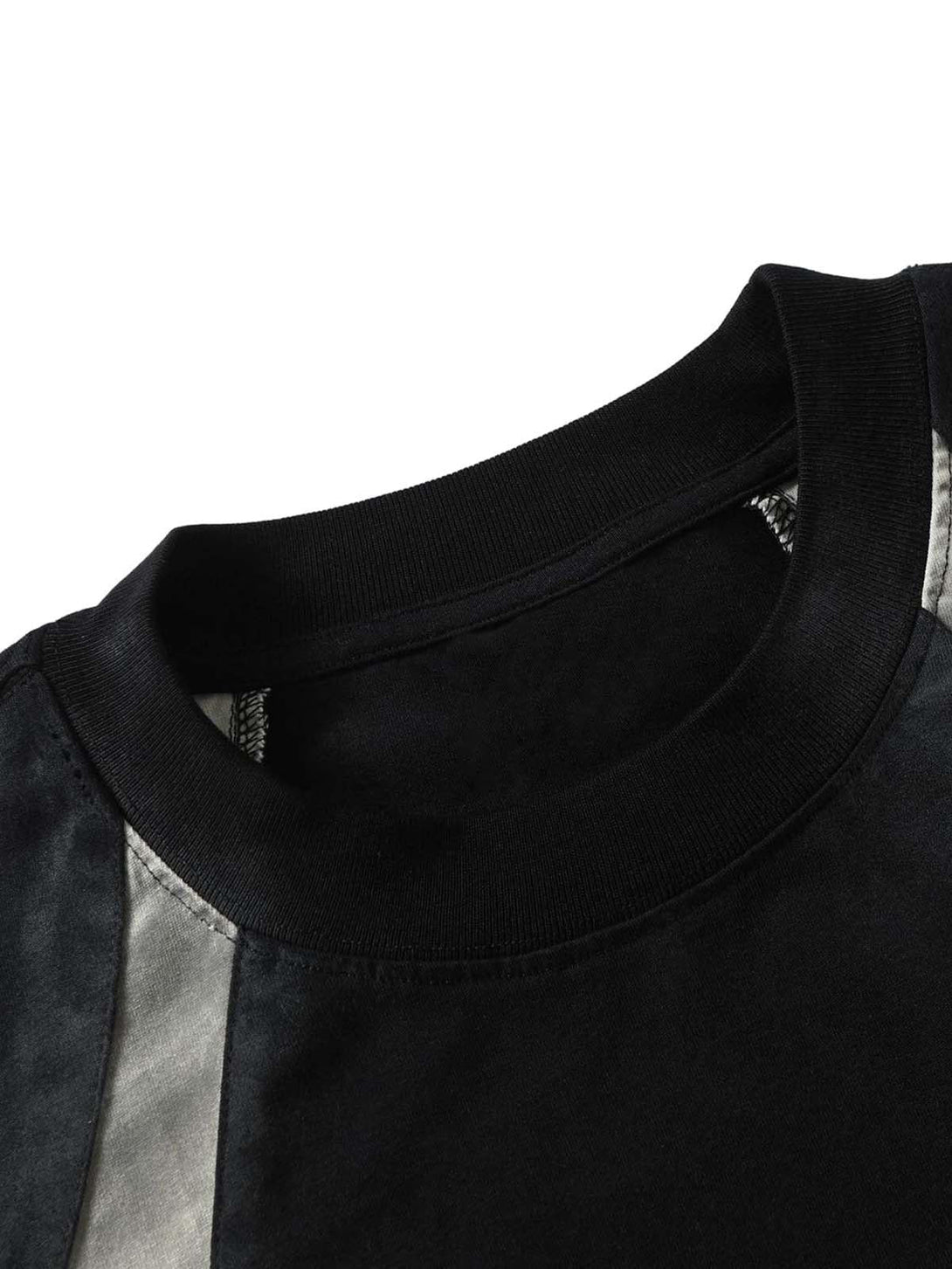 A tight crop highlighting TALISHKO's retro patchwork T-shirt neckline and texture.