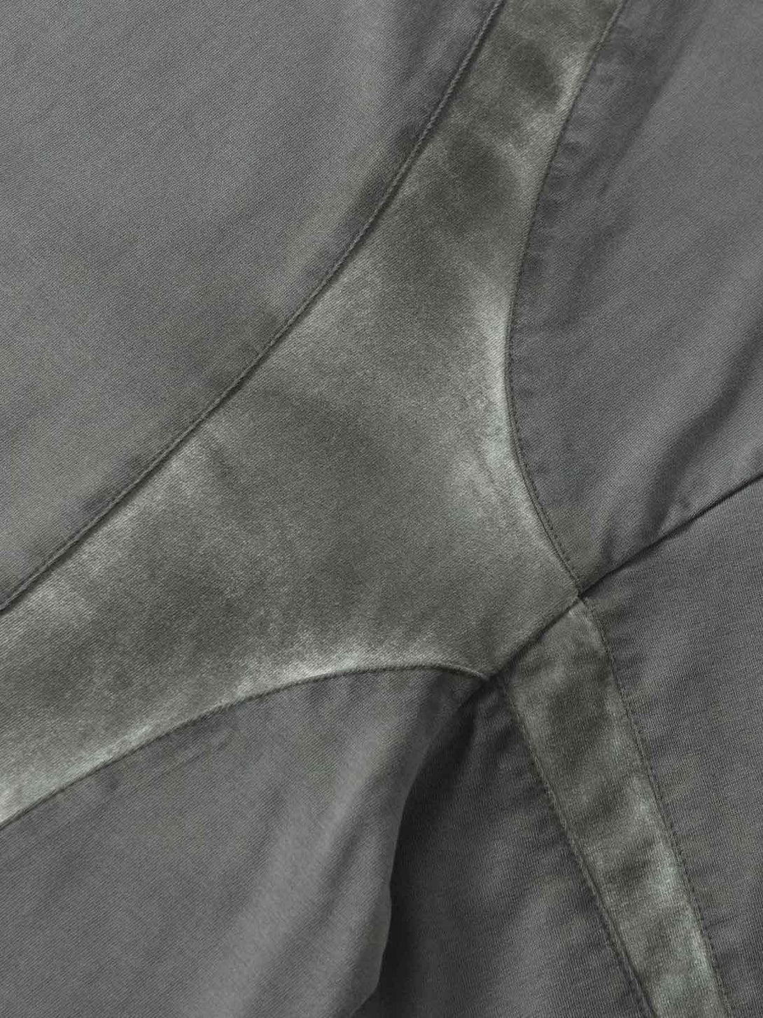 A close-up of TALISHKO's retro patchwork T-shirt, highlighting its unique texture and design.