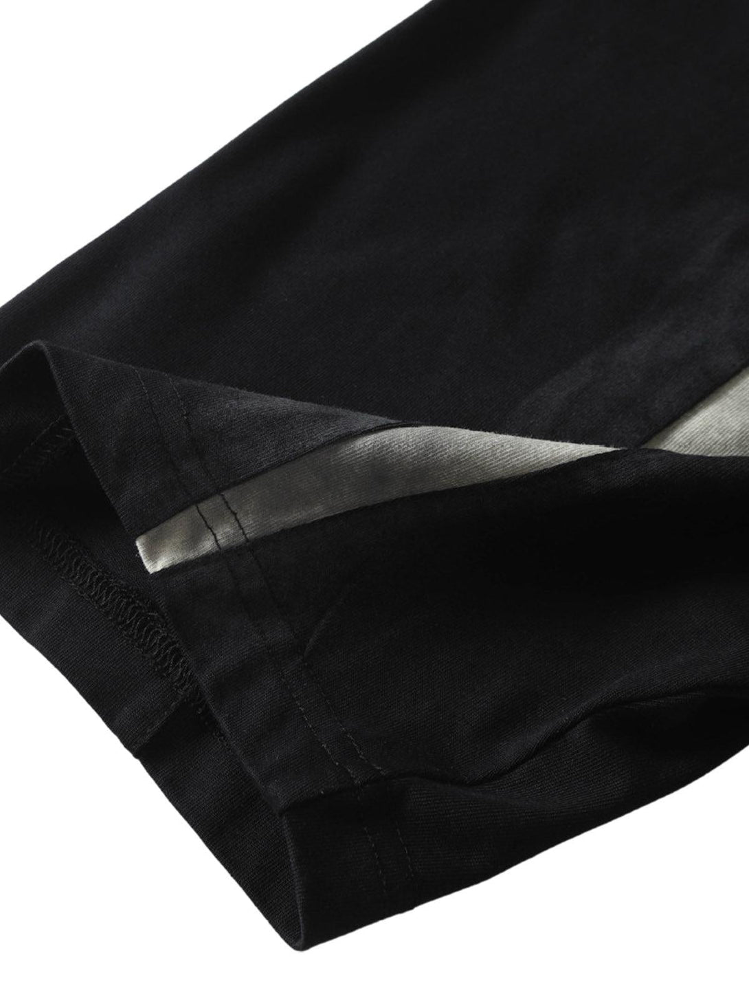 Detailed fabric and stitching of TALISHKO's retro patchwork T-shirt, highlighting its unique design.