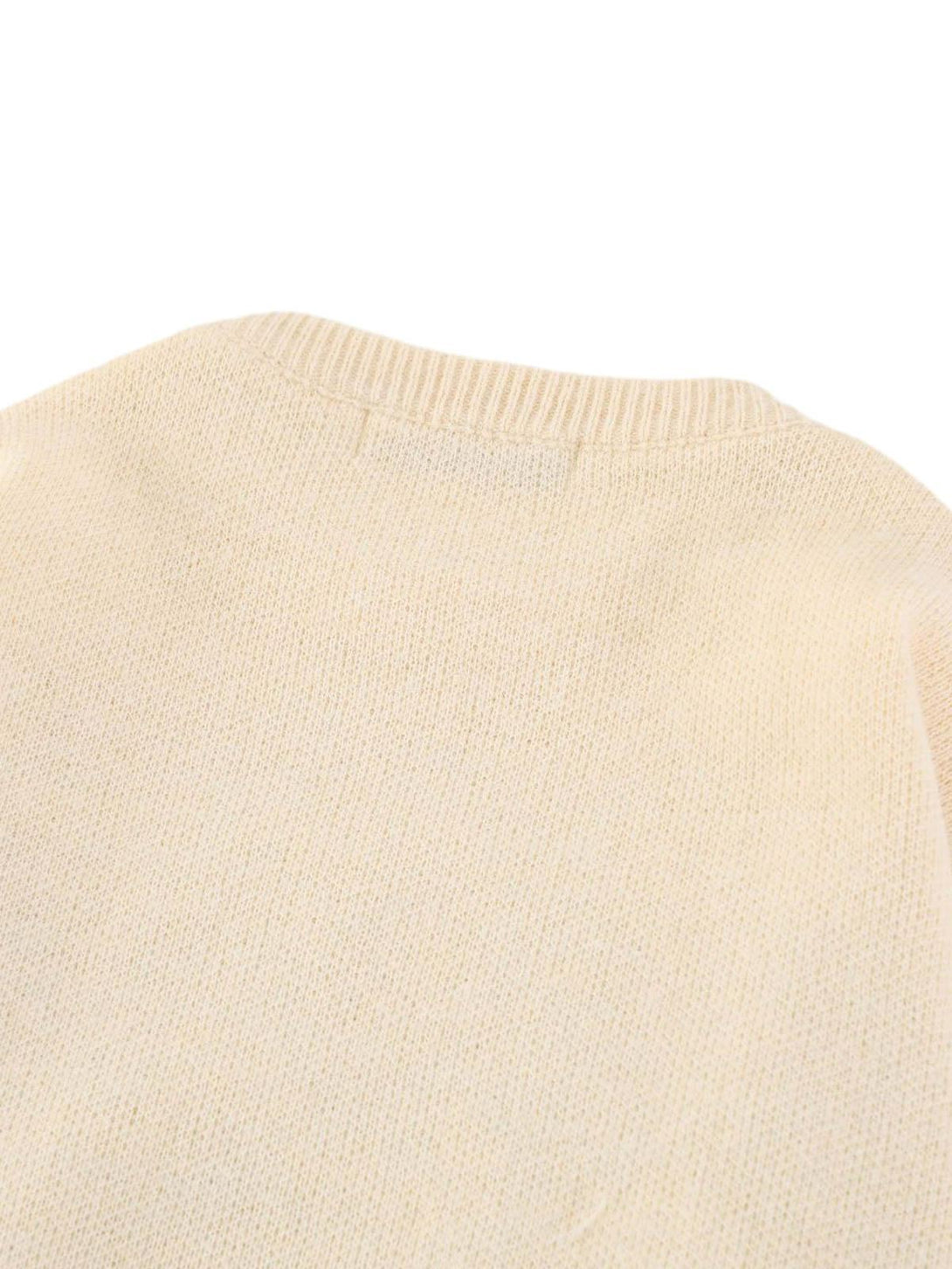 Textured knit detail on a TALISHKO retro gradient crewneck sweater in a neutral shade.