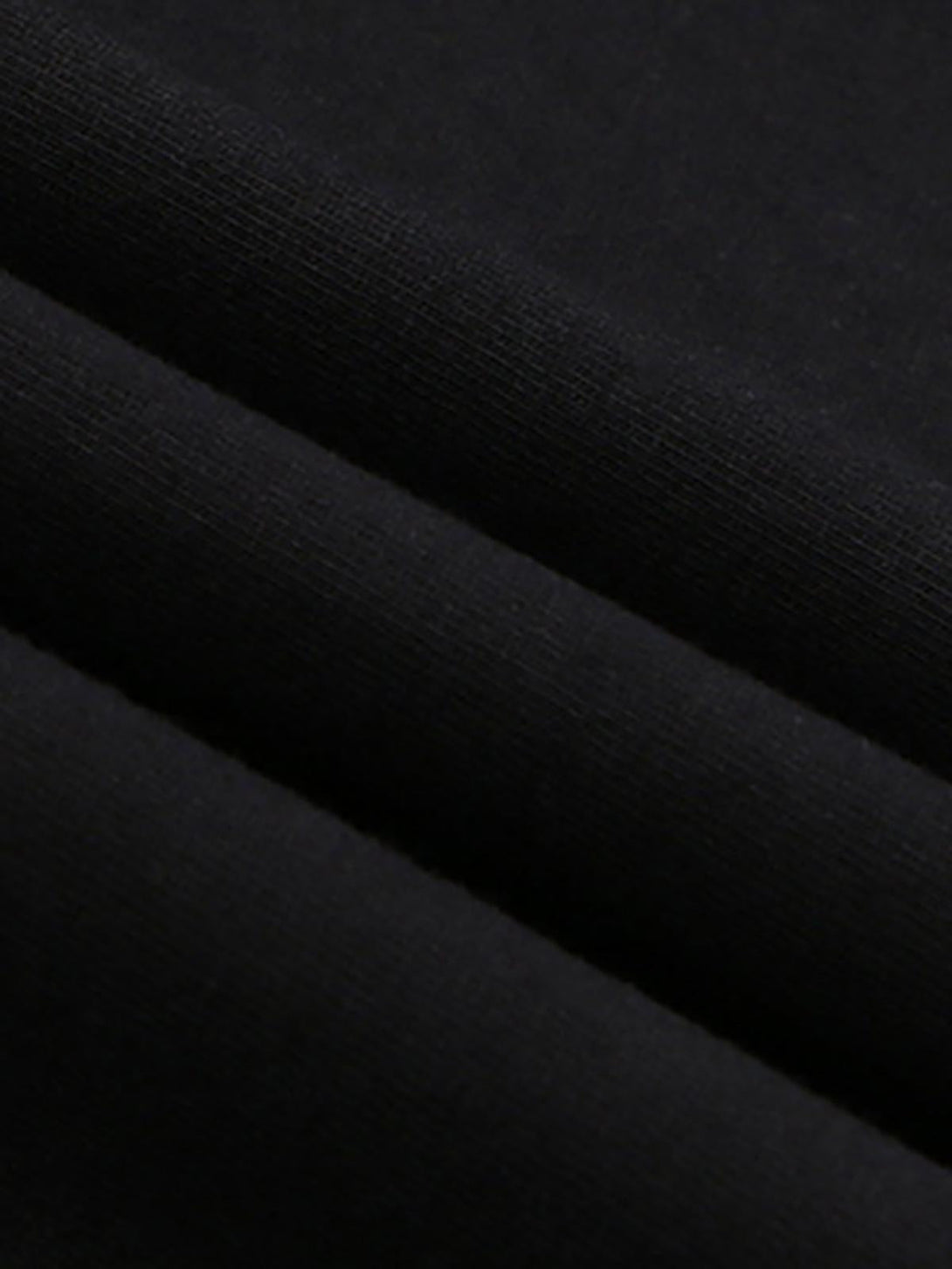 A close-up of TALISHKO's black T-shirt fabric, highlighting its soft texture and quality weave.