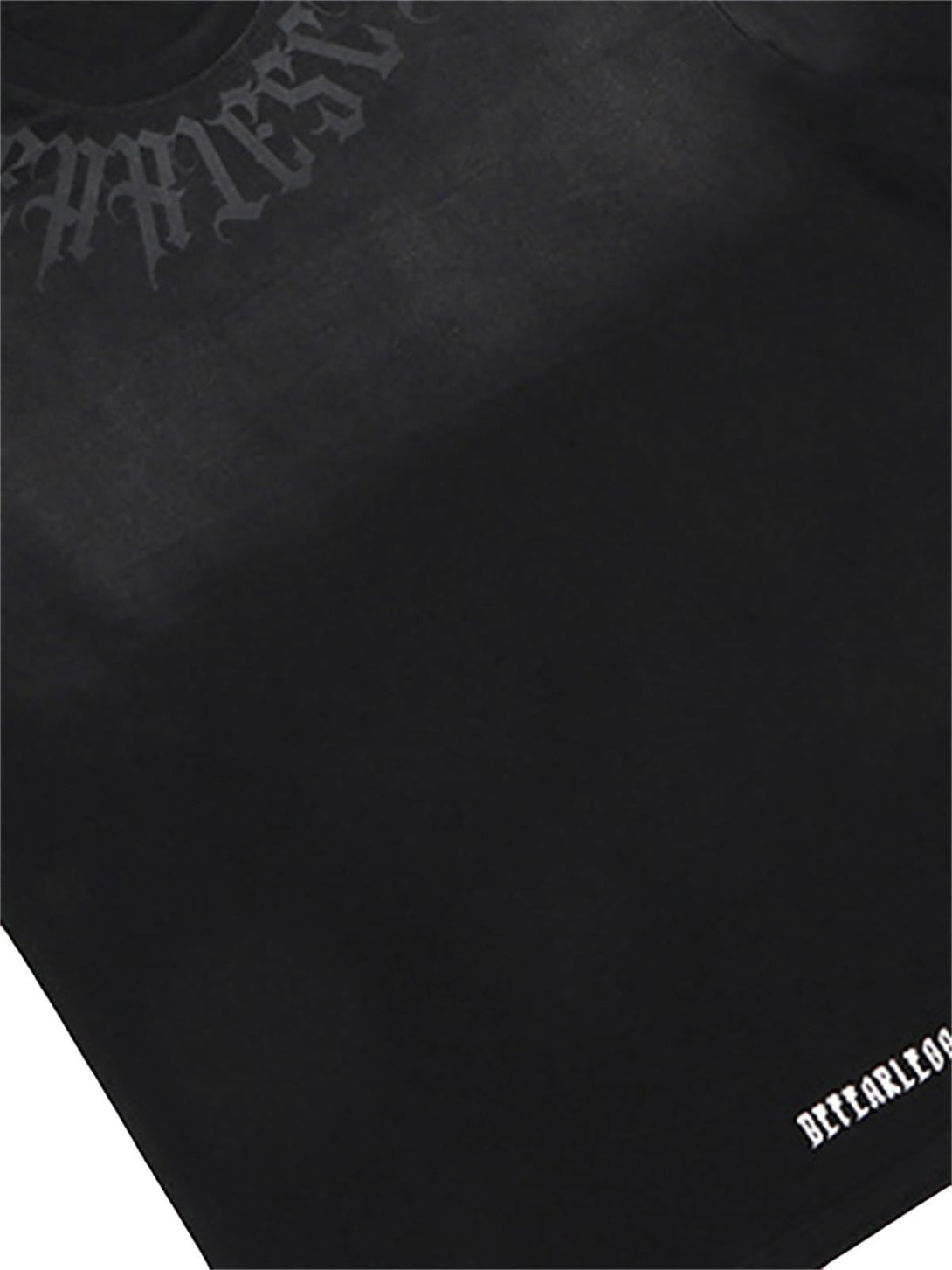 A tight crop highlighting TALISHKO's black T-shirt, featuring retro gradient letter details.