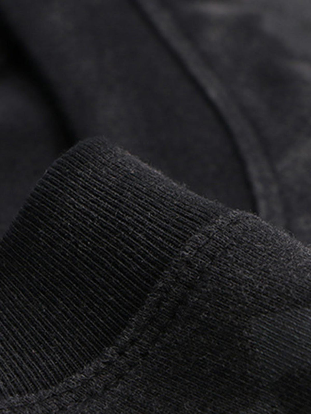 Intricate look at TALISHKO's T-shirt fabric, showcasing soft texture and quality stitching.