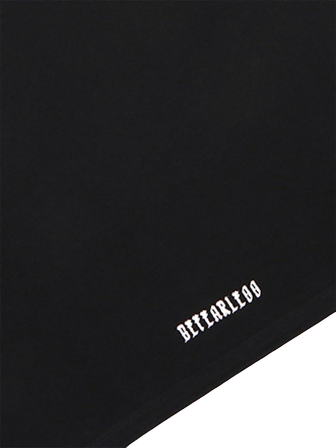 A detailed look at the TALISHKO black T-shirt's hem, featuring retro gradient lettering.