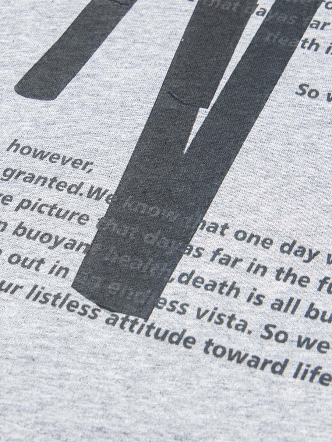 Zoomed-in view of TALISHKO T-shirt fabric, showcasing retro lettering design details.