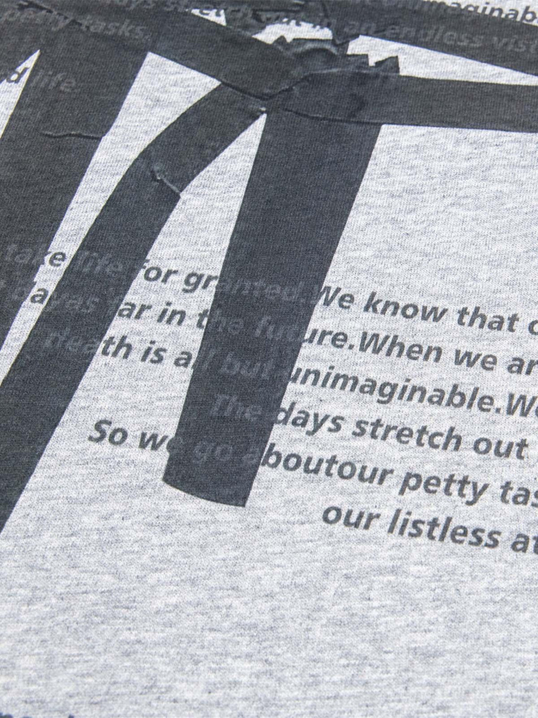 Detailed look at TALISHKO T-shirt fabric, highlighting unique retro lettering design.